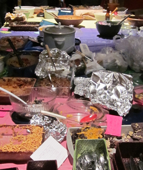 bowls, utensils, tin foil and other potluck debris