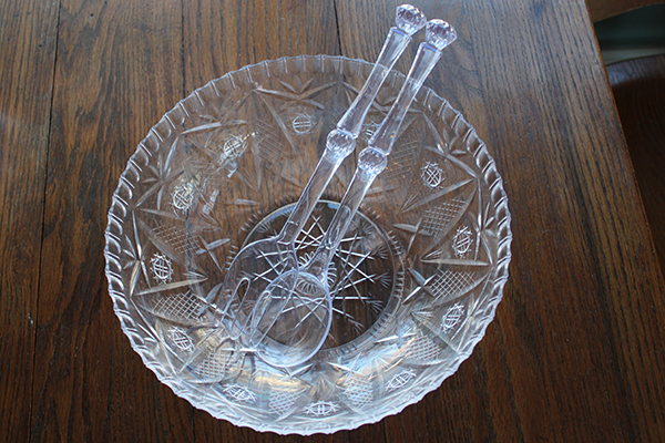 Clear plastic bowl and serving utensils.